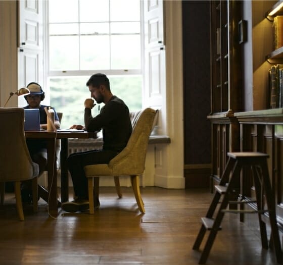 Man studying at desk in a library